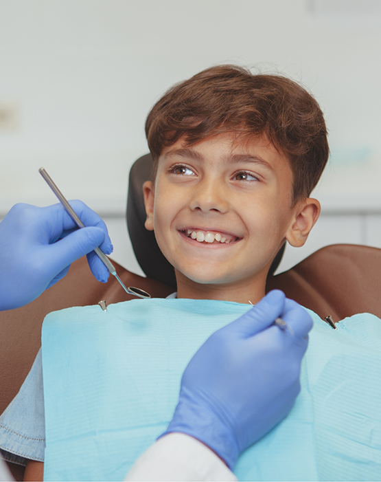 Little boy in dental chair smiling