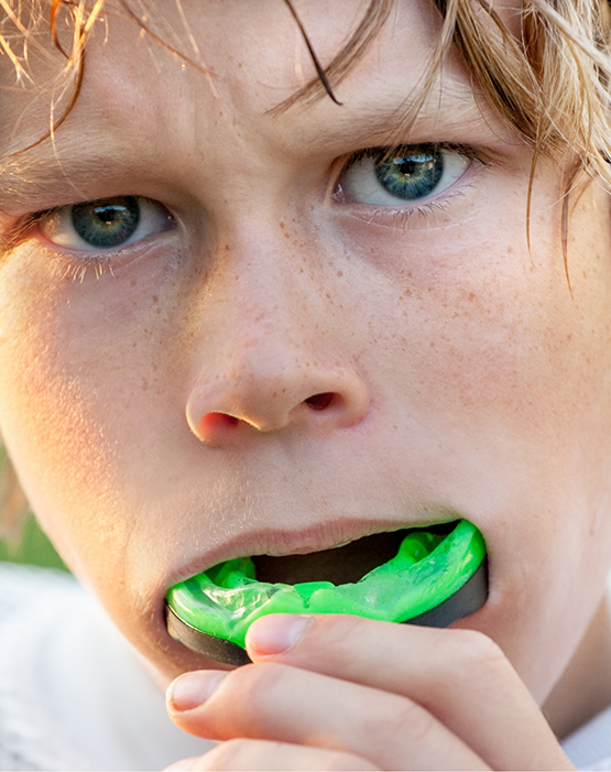 Close up of little boy with an athletic mouthguard
