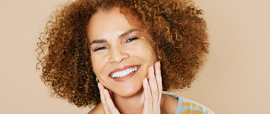 Woman with curly hair showing off her smile