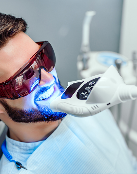 Man with beard having professional teeth whitening performed