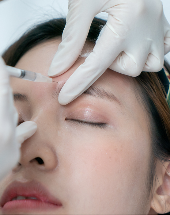 Receiving BOTOX injection in forehead