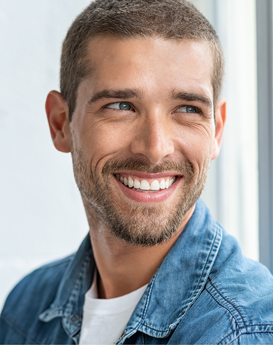 Man in denim jacket smiling