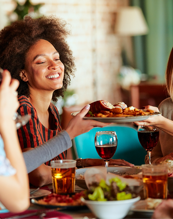 Woman passing plate at dinner table