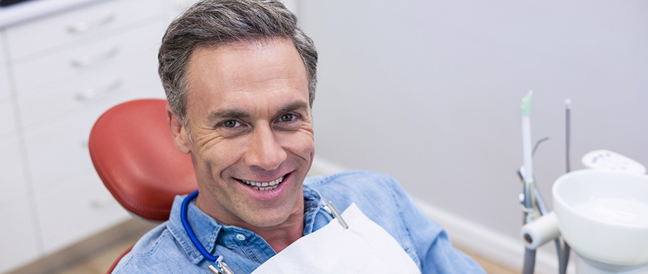 Man with denim jacket sitting in dental chair
