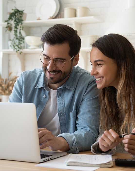 Man and woman looking at a laptop together