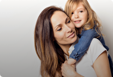 Young woman giving little girl a piggyback ride