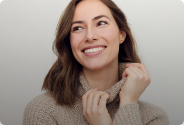 Young woman in turtleneck sweater smiling