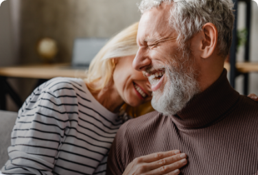 Older man and woman sitting on couch