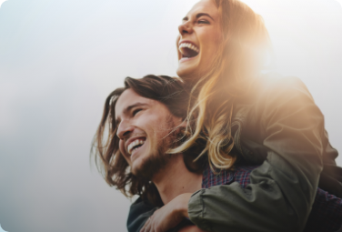 Man giving woman a piggyback ride outdoors