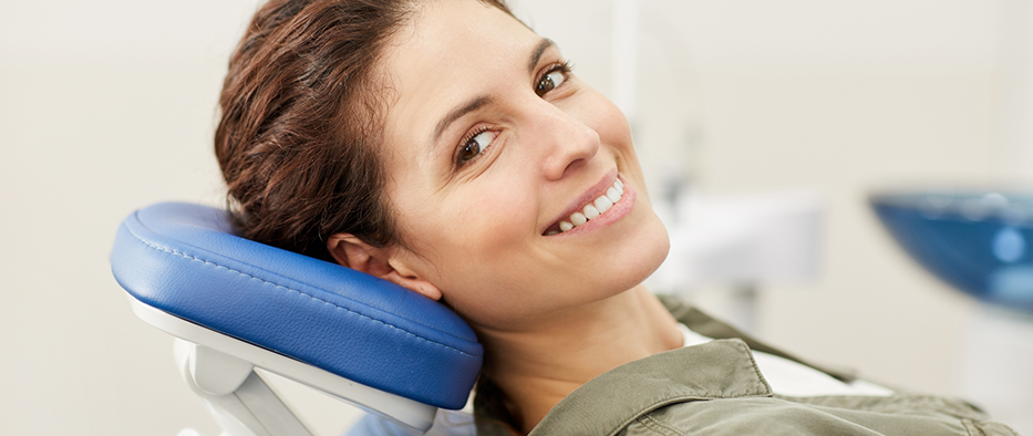 Woman lying back in the dental chair and smiling